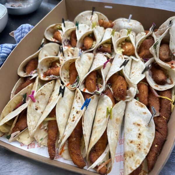 Tacos with panko chicken, spiced slaw, salsa and cheese